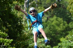 Alec riding a zip line