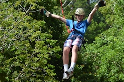 Noah riding a zip line